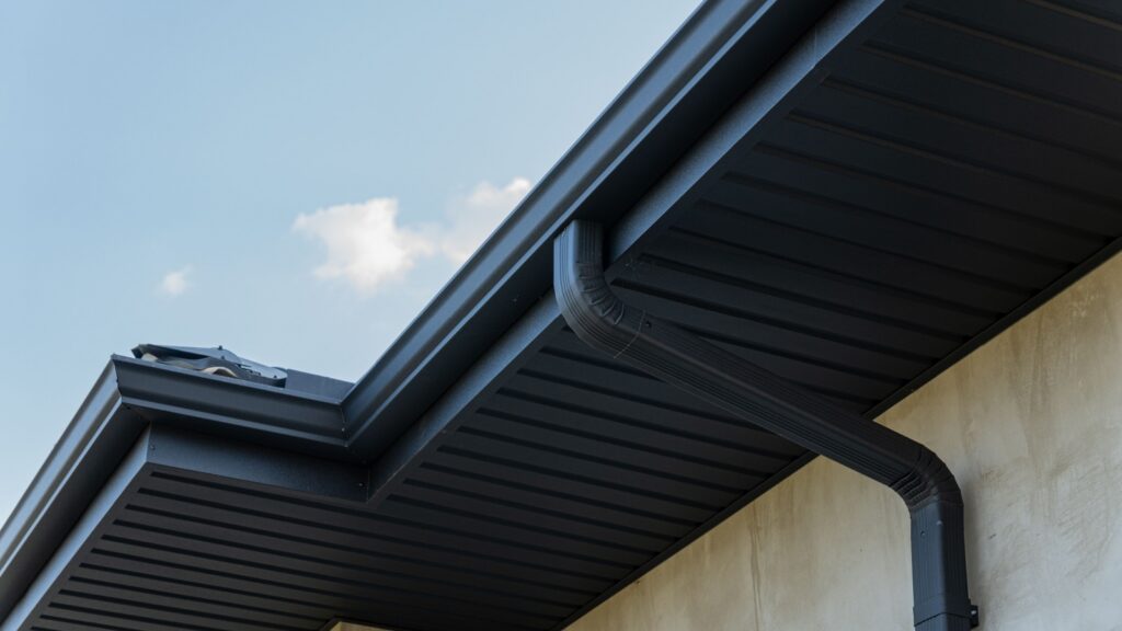 Black seamless gutters installed by Bumble Roofing in Colorado Springs, CO.