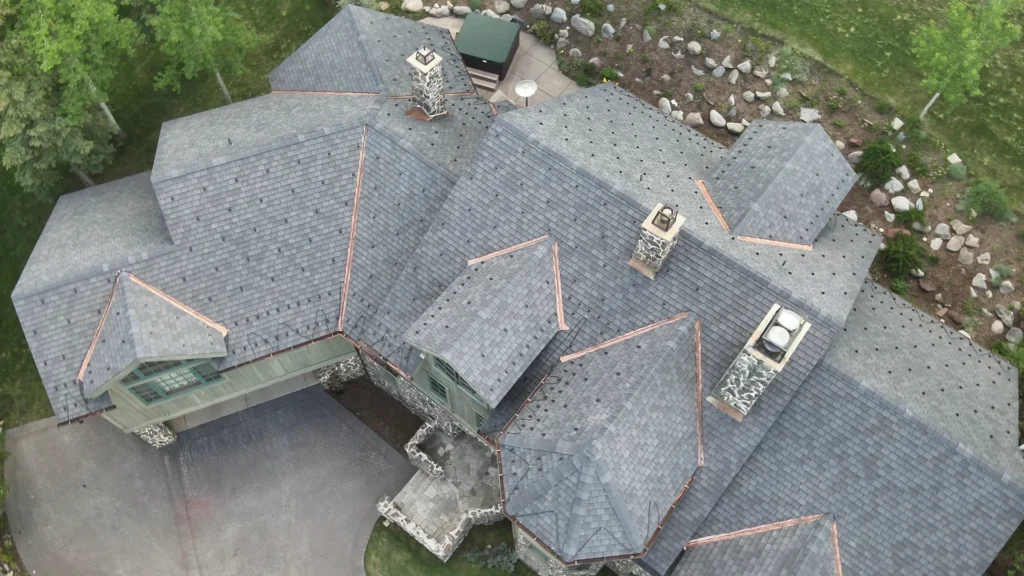 Aerial view of finished F-Wave XTD synthetic slate roof installation on luxury Snowmass Village mountain home