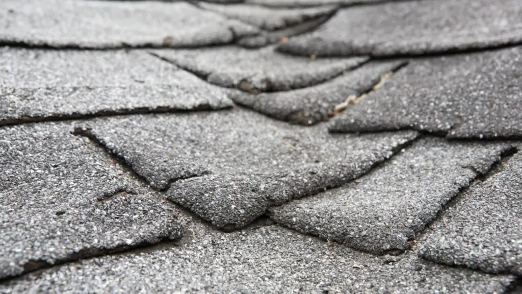 Intense heat exposure cracks and curls asphalt roofing in Forsyth, GA.