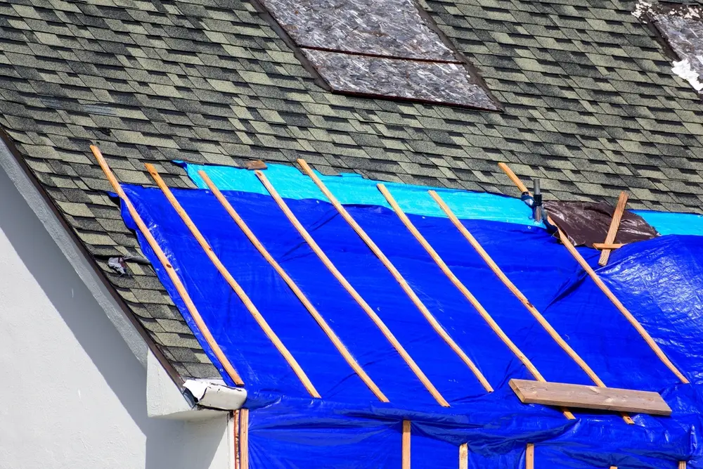 Emergency roof tarp used to patch damage after a storm in North Atlanta.