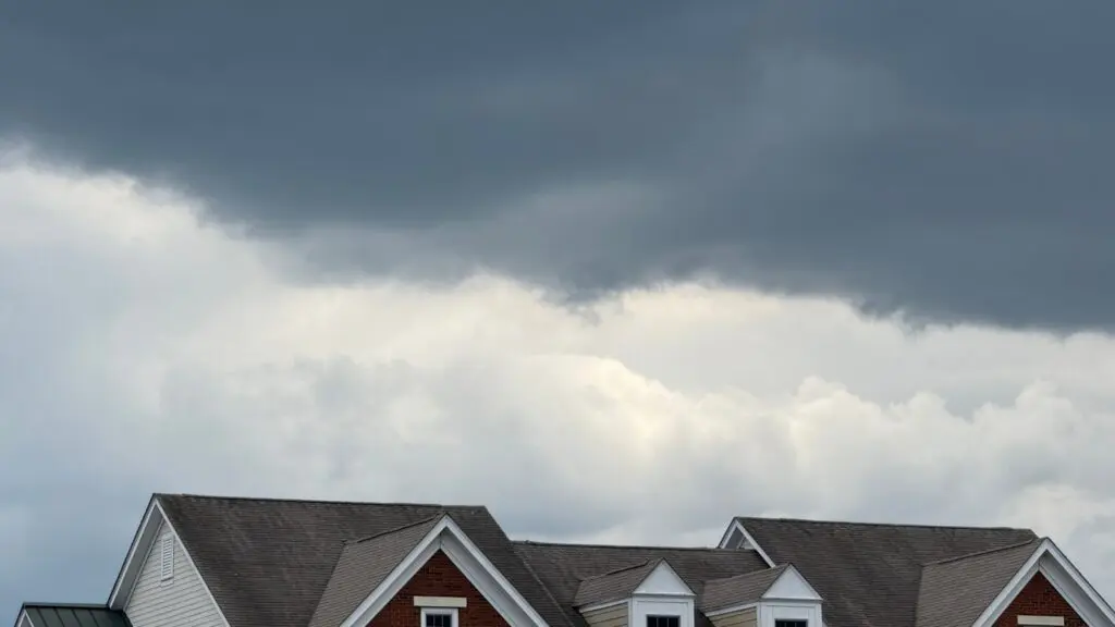 Dark clouds loom over a home with impact resistant roofing in Richmond, VA.