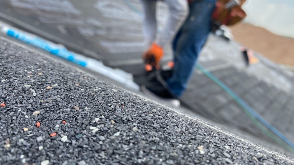 A closeup of new asphalt shingles installed by Bumble Roofing during winter in North Houston.
